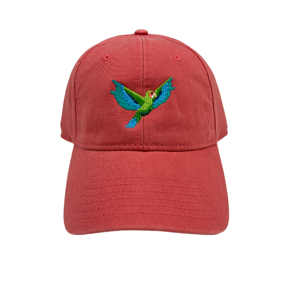 red tabs cap featuring the cayman islands national bird - the cayman parrot.