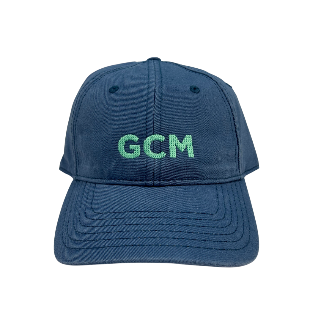 tabs slate blue cap with needlepoint embroidery of gcm which is the airport code for grand cayman